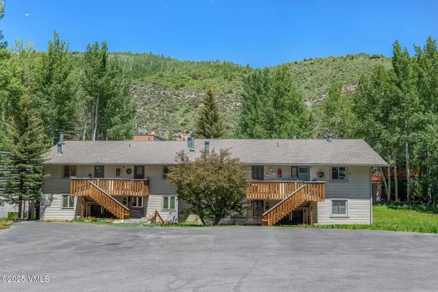 an aerial view of a house with large trees