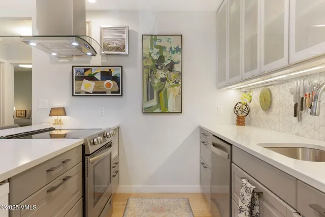 a kitchen with stainless steel appliances granite countertop a sink and a microwave