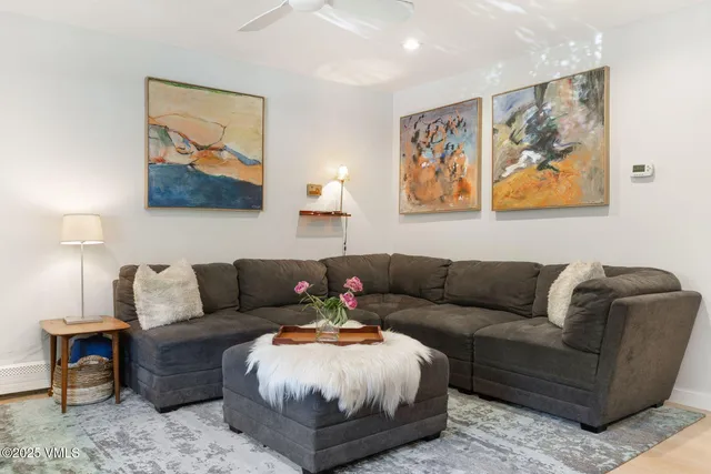 a living room with furniture and wall painting