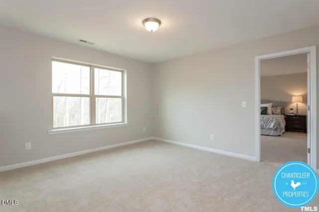 an empty room with window and mirror