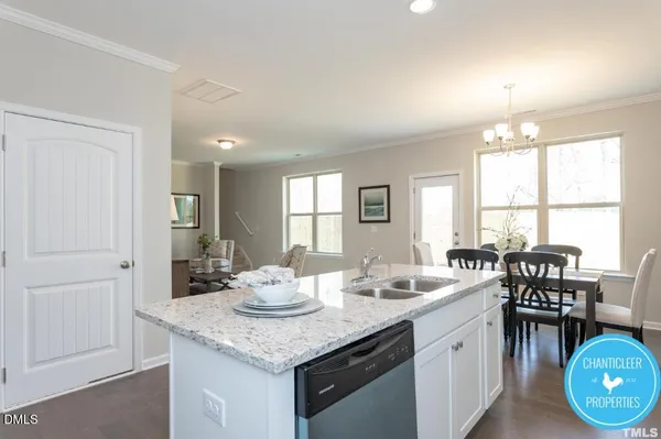 a open dining room with stainless steel appliances kitchen island granite countertop a dining table and chairs