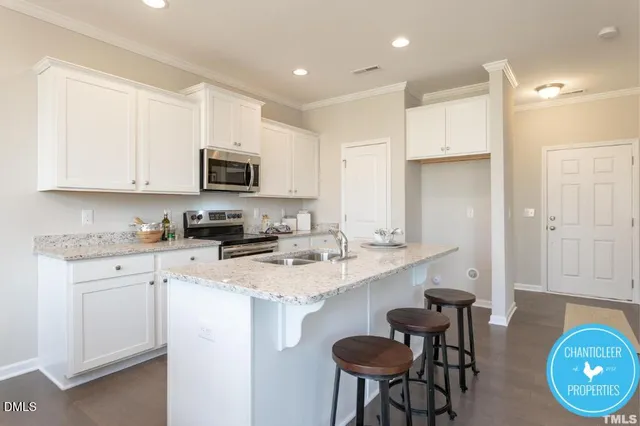 a kitchen with a sink cabinets and wooden floor
