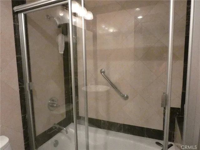 a bathroom with a glass shower door