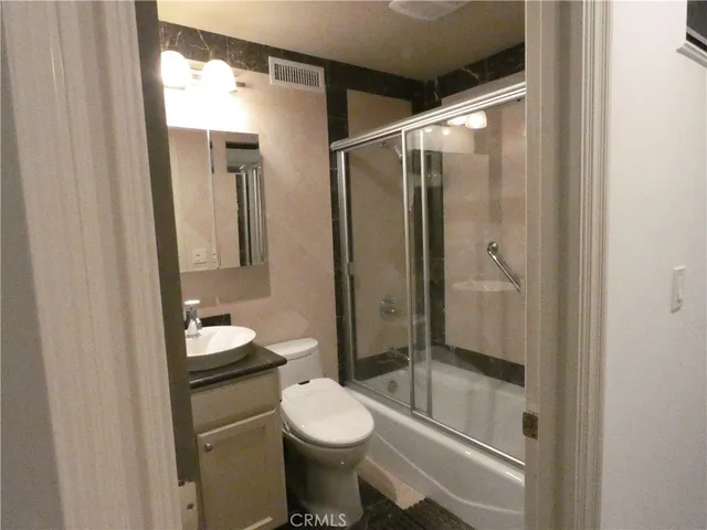 a bathroom with a toilet sink and shower