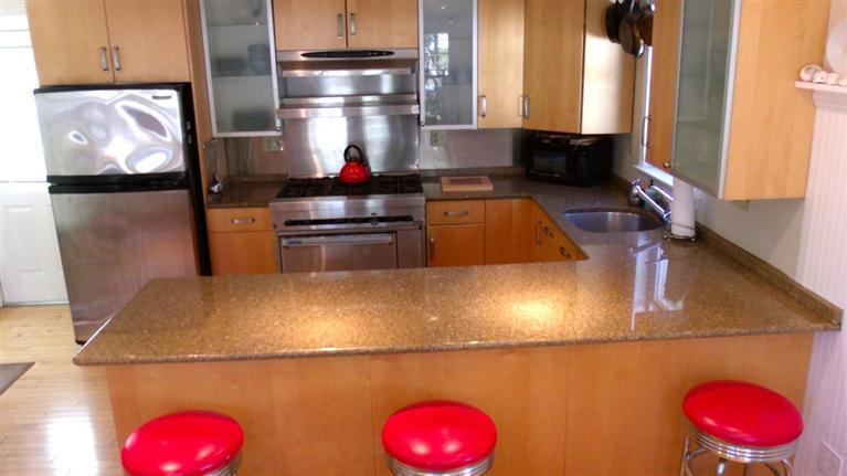 72 Shore Road Truro, MA 02666 - Photo 10 of 15 a kitchen with a stove a refrigerator and wooden floor