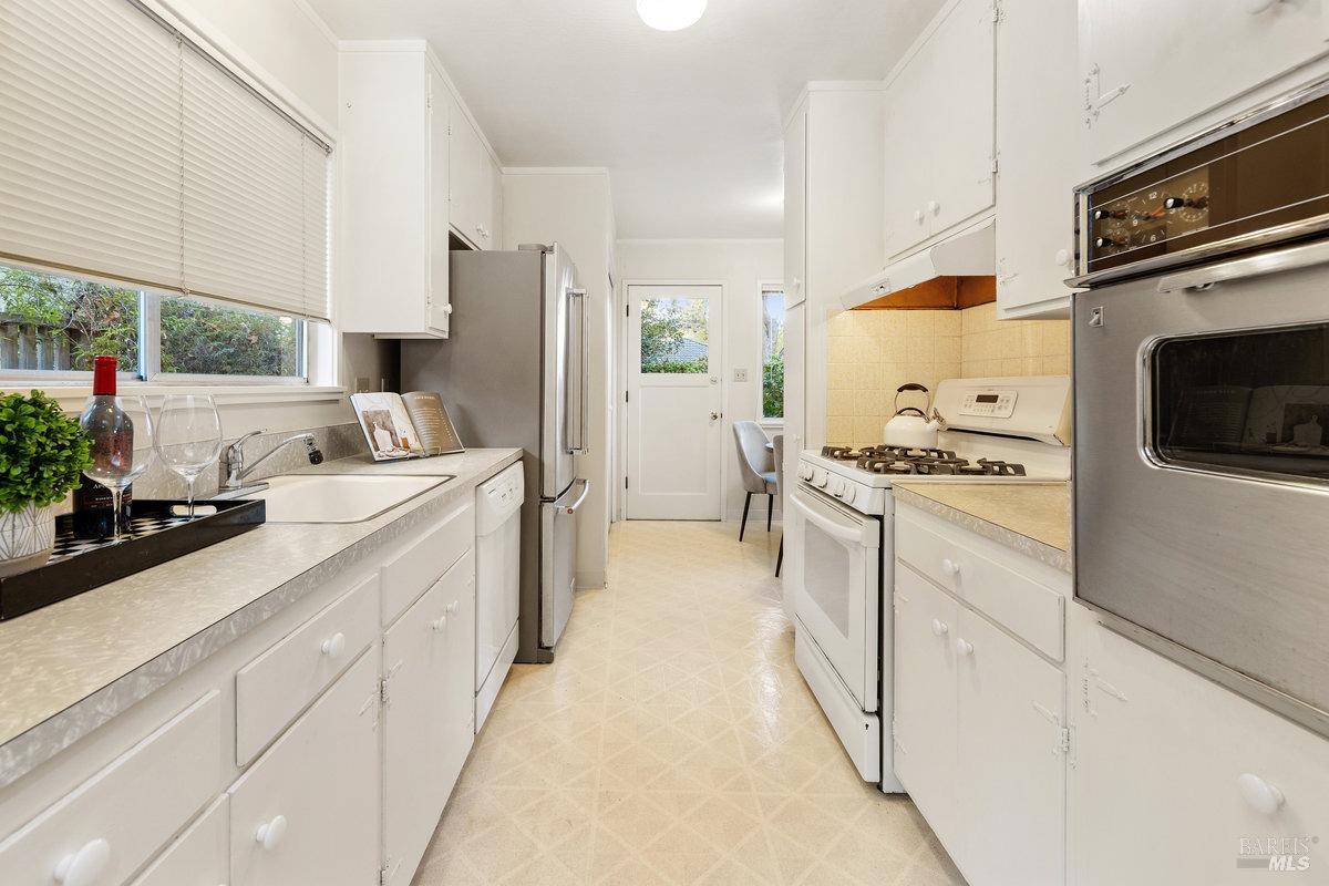 29 Locust Avenue Mill Valley, CA 94941 - Photo 5 of 26 a kitchen with cabinets and white appliances