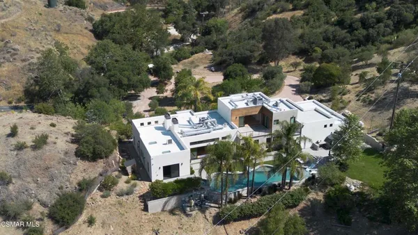 an aerial view of a house with a yard