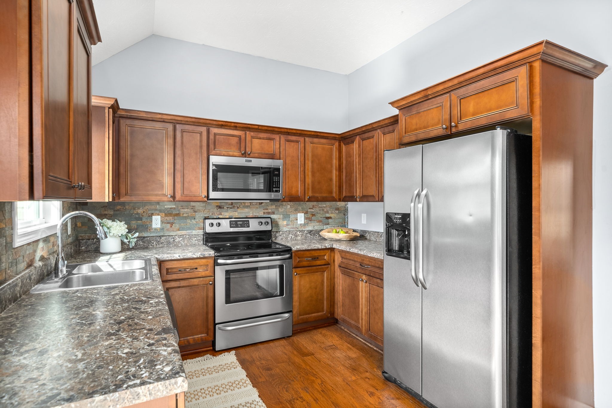 1105 Pleasant Valley Road Chapmansboro, TN 37035 - Photo 11 of 30 a kitchen with stainless steel appliances granite countertop a refrigerator stove microwave and sink