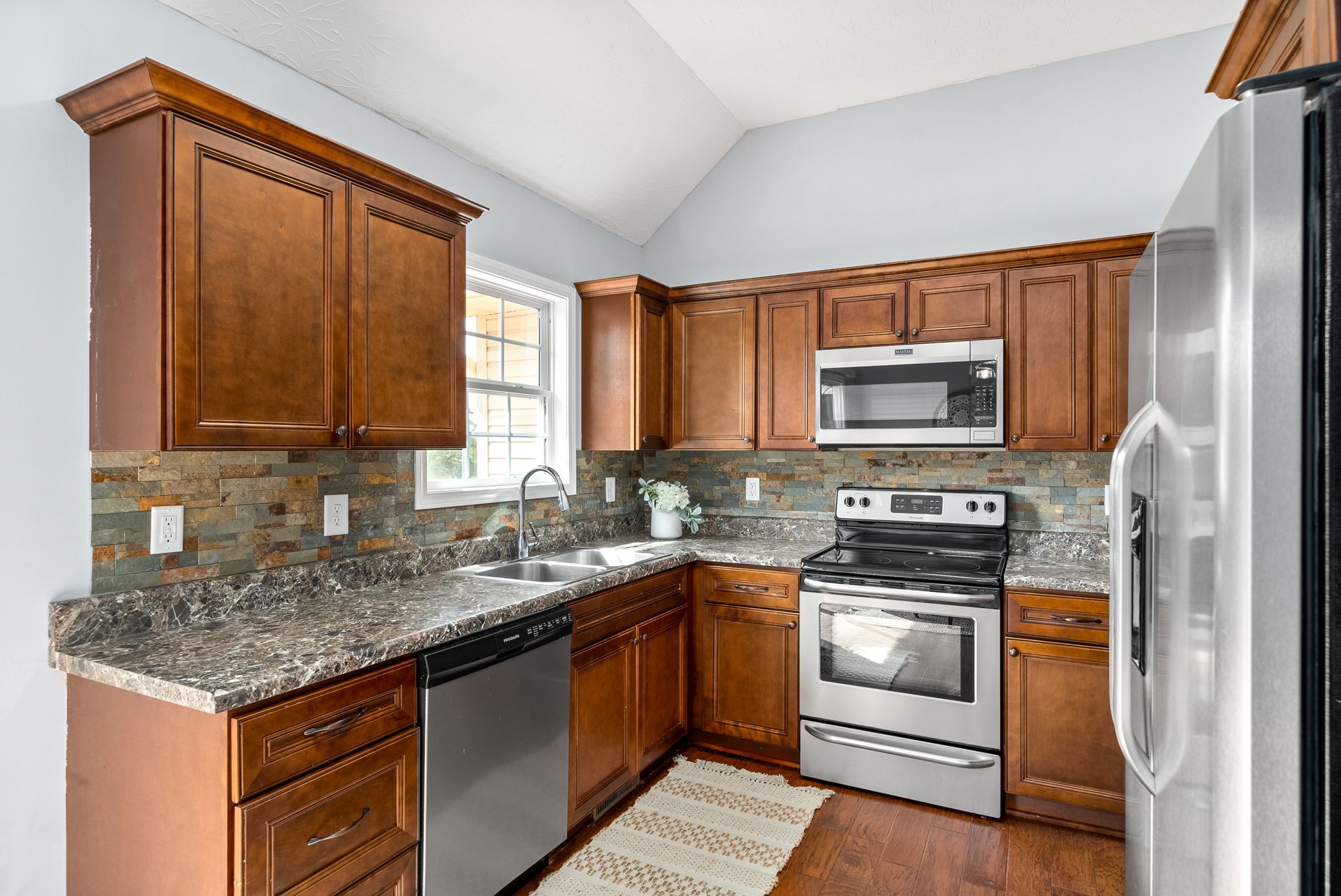 1105 Pleasant Valley Road Chapmansboro, TN 37035 - Photo 12 of 30 a kitchen with a sink stove and microwave