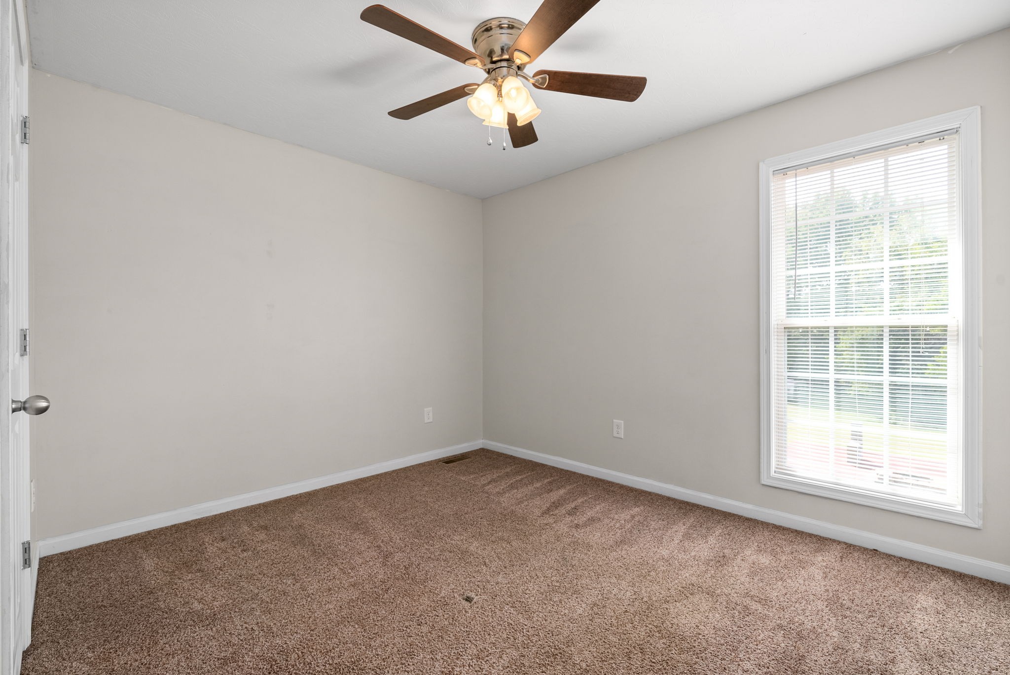 1105 Pleasant Valley Road Chapmansboro, TN 37035 - Photo 21 of 30 an empty room with a window and a fan