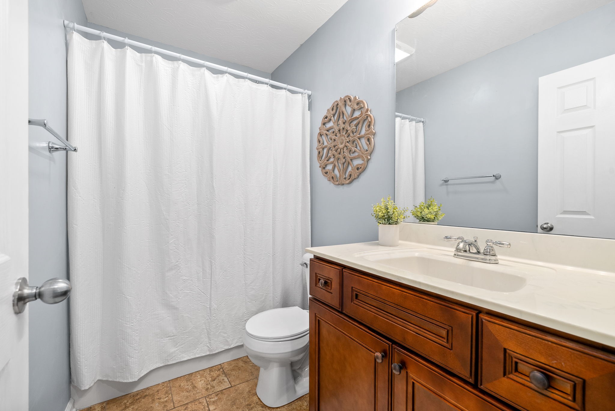 1105 Pleasant Valley Road Chapmansboro, TN 37035 - Photo 22 of 30 a bathroom with a sink mirror vanity and toilet