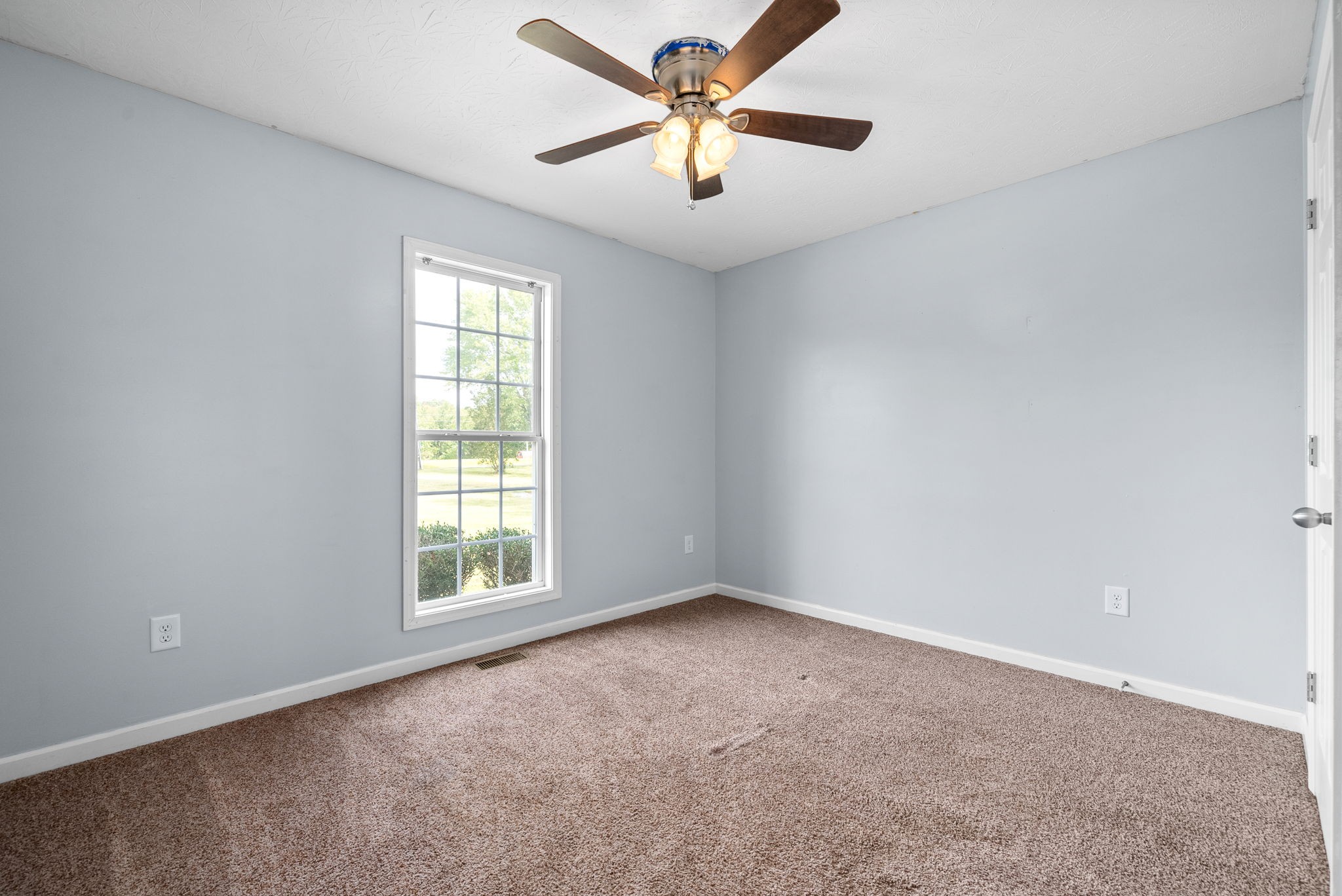 1105 Pleasant Valley Road Chapmansboro, TN 37035 - Photo 23 of 30 an empty room with windows and fan