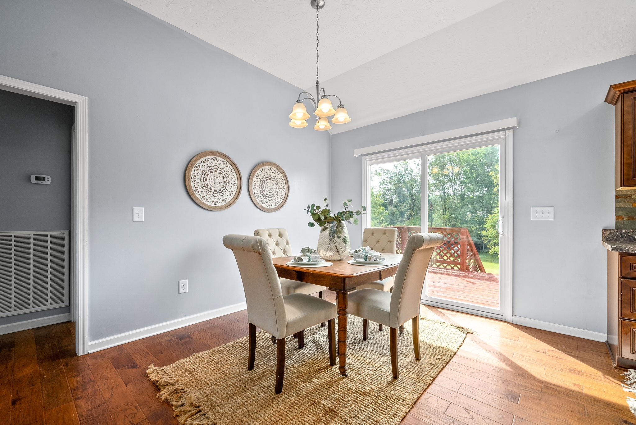 1105 Pleasant Valley Road Chapmansboro, TN 37035 - Photo 9 of 30 a view of a dining room with furniture a chandelier and wooden floor