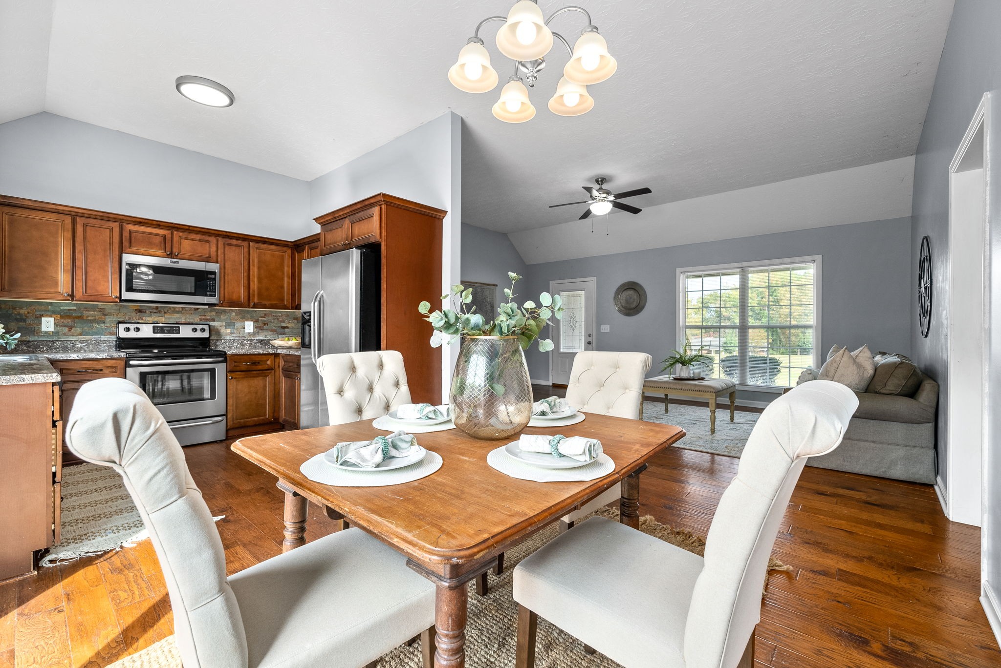 1105 Pleasant Valley Road Chapmansboro, TN 37035 - Photo 10 of 30 a view of a dining room with furniture a chandelier and wooden floor