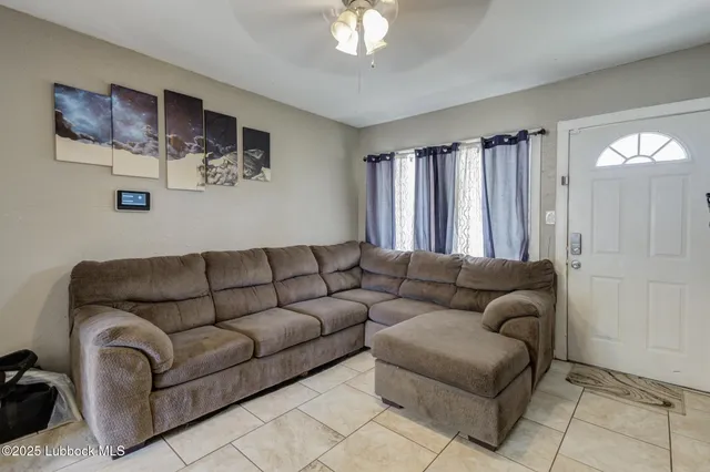 a living room with furniture and a large window
