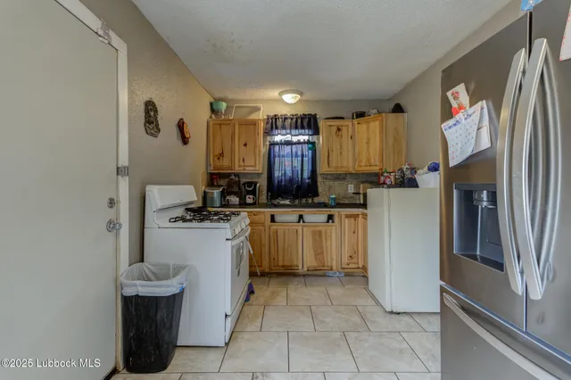 a kitchen with a refrigerator and a sink