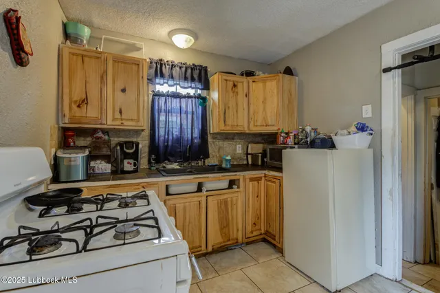 a kitchen with stainless steel appliances a stove a sink and a refrigerator