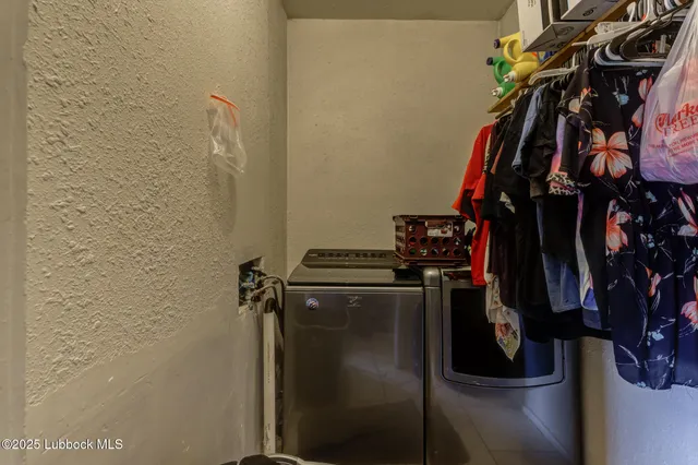 a view of walk in closet with clothes