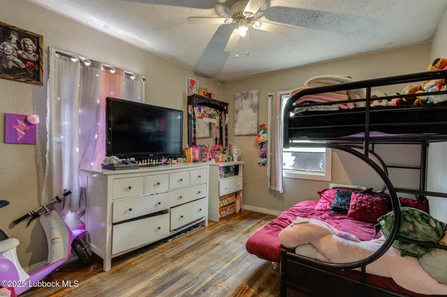 a bedroom with furniture and flat screen tv