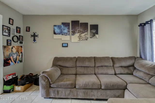 a living room with furniture and kitchen view