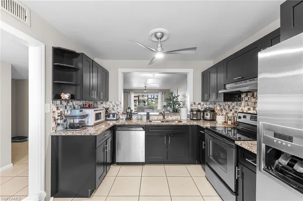 a kitchen with stainless steel appliances a sink stove and refrigerator