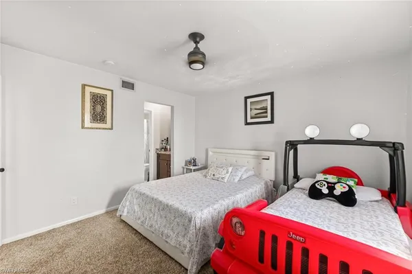 a bedroom with a bed and a dresser