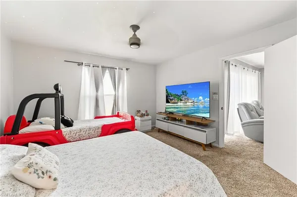 a bedroom with furniture and a flat screen tv