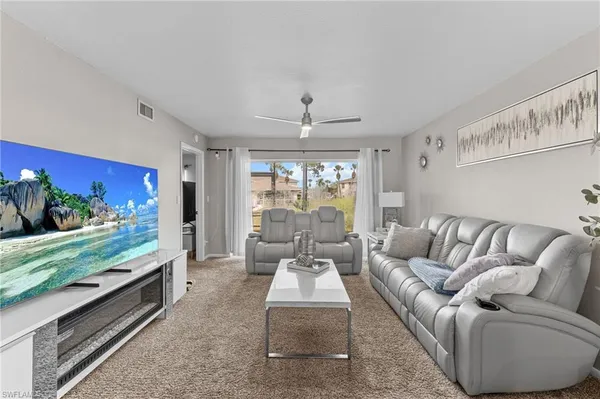 a living room with furniture and a large window