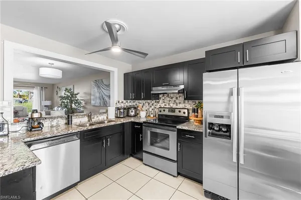 a kitchen with a sink stainless steel appliances and cabinets