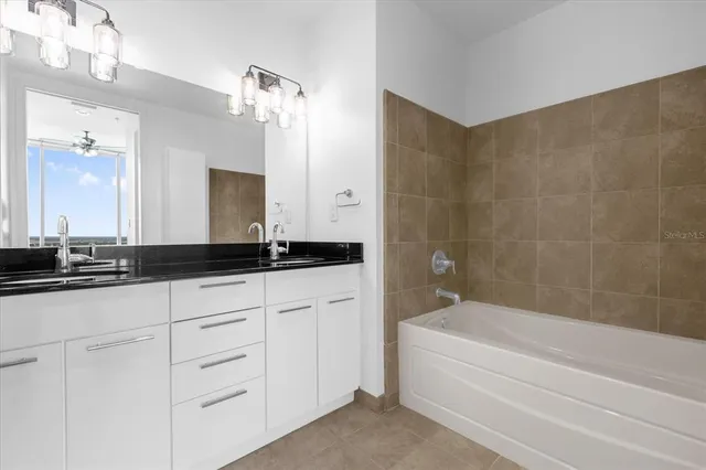 a bathroom with a bathtub a sink and a mirror