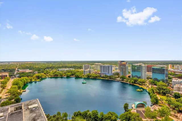 an aerial view of residential houses with outdoor space and lake view