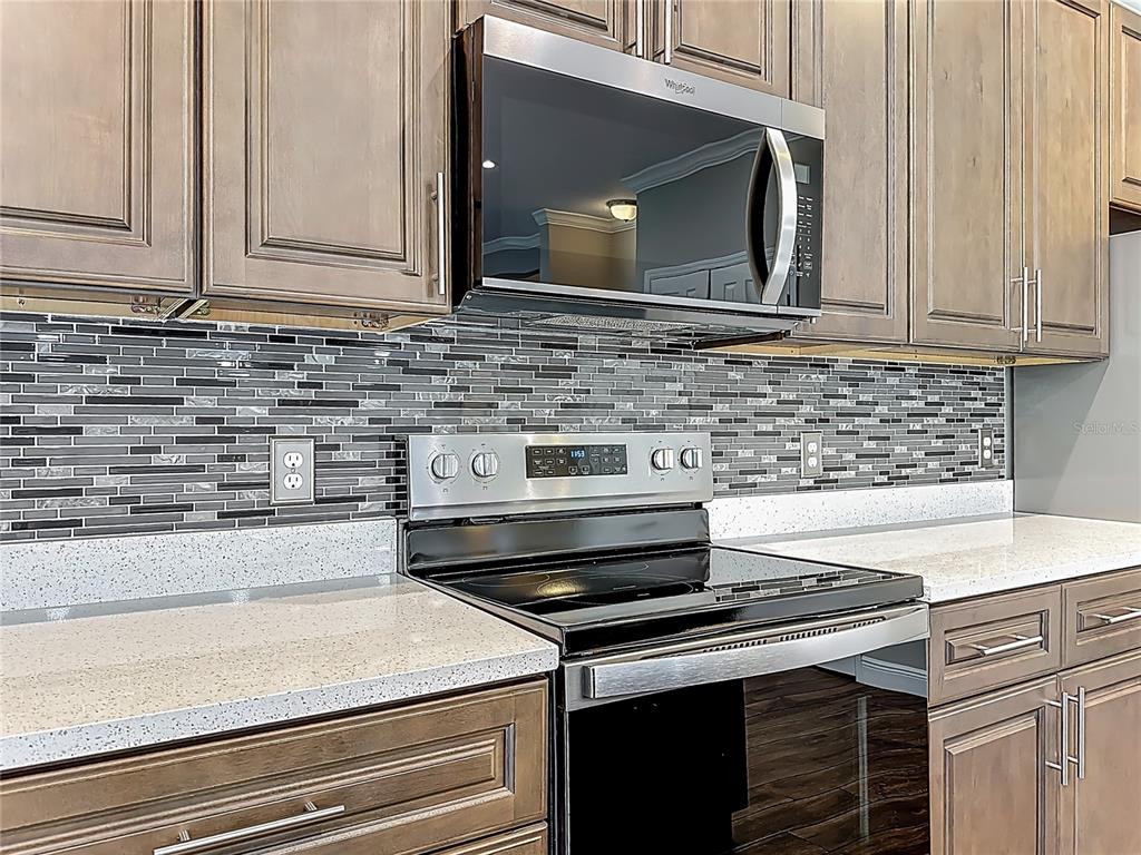 19424 Oakleaf Street Orlando, FL 32833 - Photo 12 of 43 a kitchen with stove top oven and cabinets