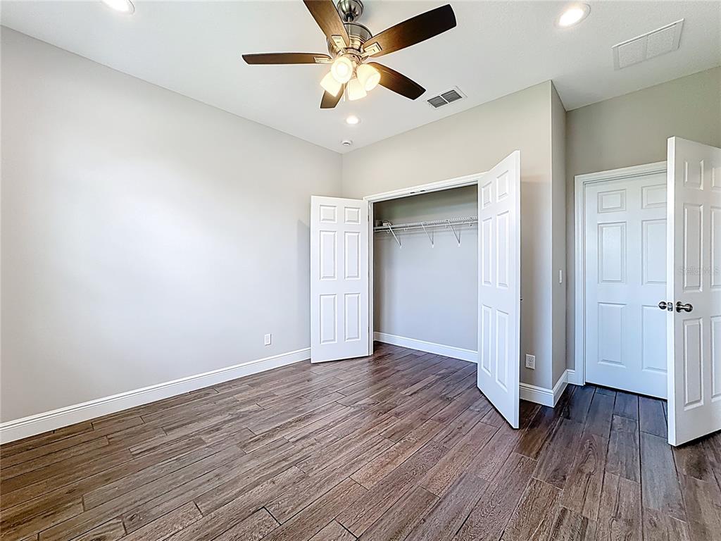 19424 Oakleaf Street Orlando, FL 32833 - Photo 15 of 43 an empty room with wooden floor and ceiling fan