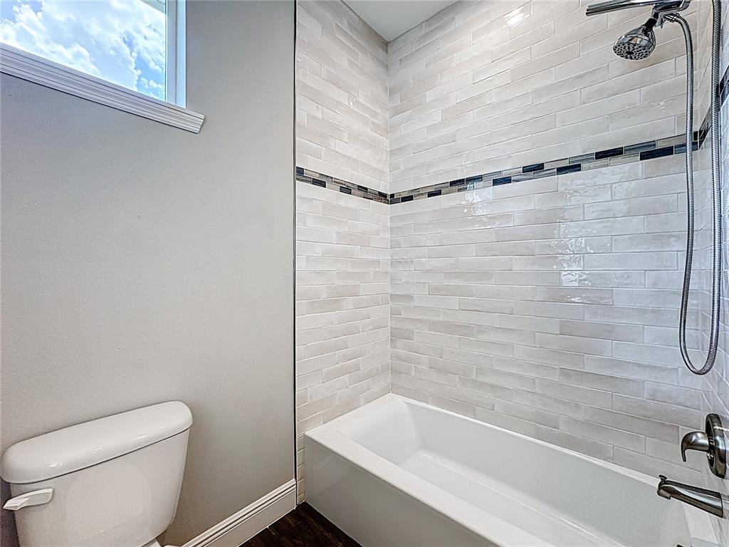 19424 Oakleaf Street Orlando, FL 32833 - Photo 24 of 43 a bathroom with a bathtub and a toilet