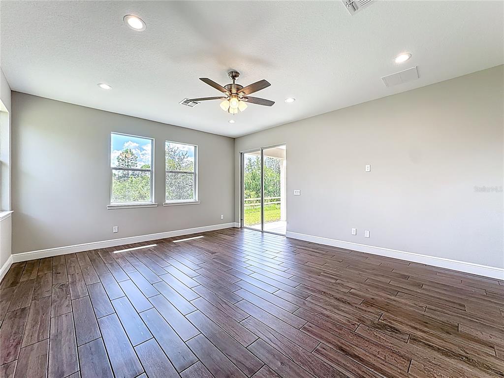19424 Oakleaf Street Orlando, FL 32833 - Photo 26 of 43 a view of an empty room with wooden floor and a window