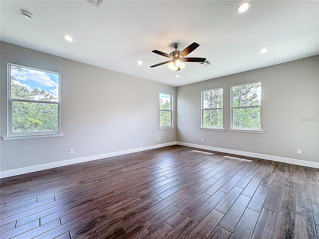 19424 Oakleaf Street Orlando, FL 32833 - Photo 27 of 43 a view of an empty room with wooden floor and a window