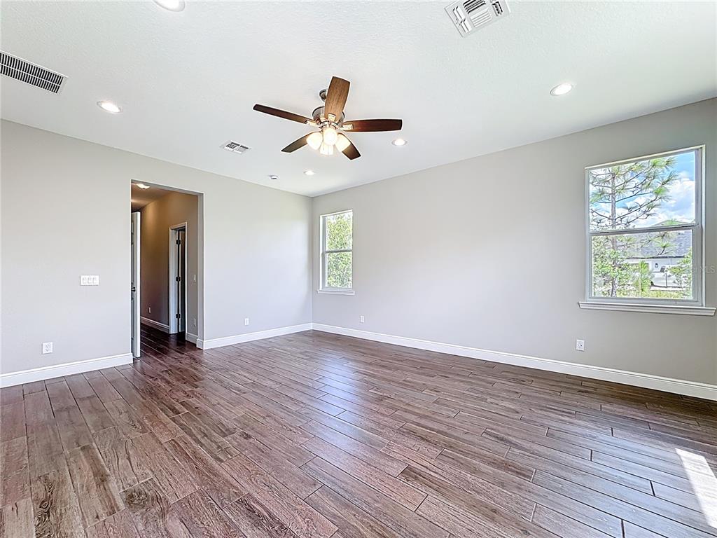 19424 Oakleaf Street Orlando, FL 32833 - Photo 28 of 43 wooden floor in an empty room with a window
