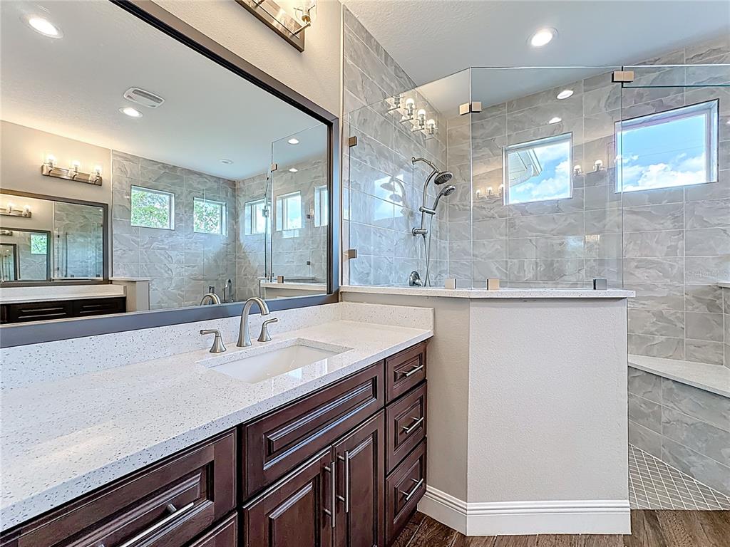 19424 Oakleaf Street Orlando, FL 32833 - Photo 31 of 43 a bathroom with a sink a vanity and a large mirror