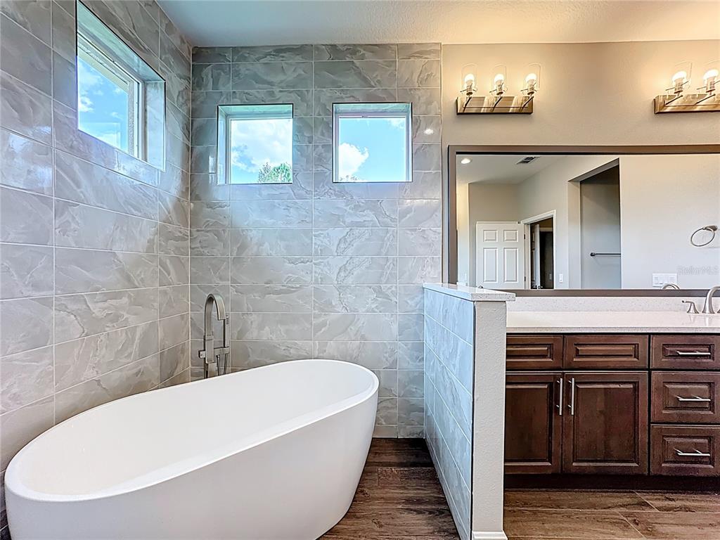 19424 Oakleaf Street Orlando, FL 32833 - Photo 33 of 43 a bathroom with a bathtub and a sink