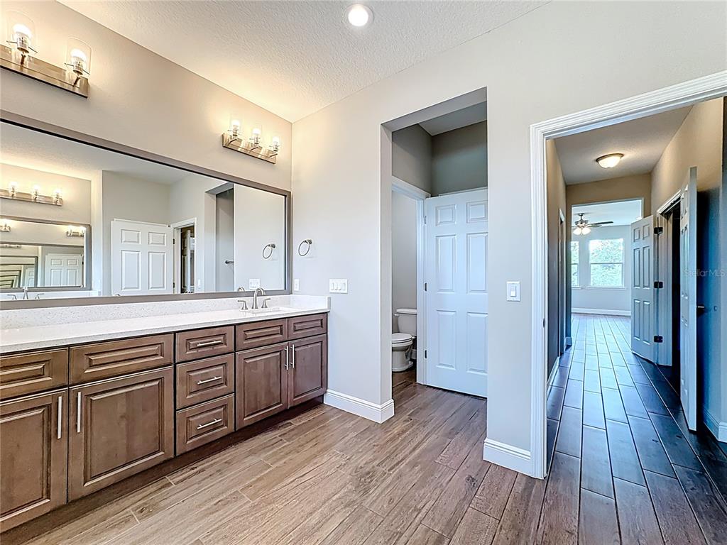 19424 Oakleaf Street Orlando, FL 32833 - Photo 34 of 43 a bathroom with a sink a mirror and a shower