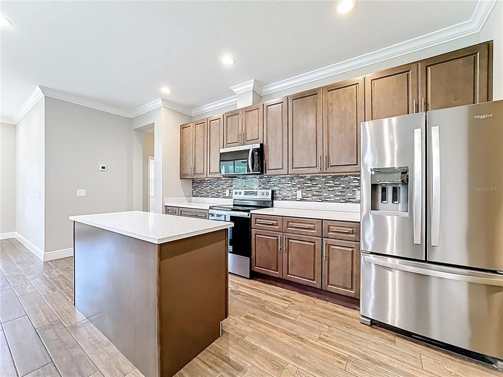 19424 Oakleaf Street Orlando, FL 32833 - Photo 10 of 43 a kitchen with a refrigerator stove and microwave