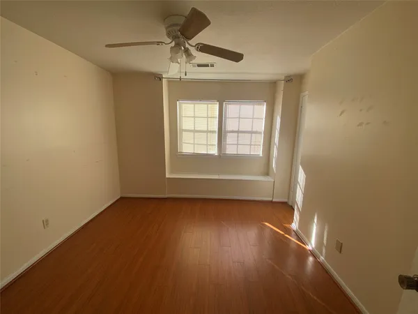 a view of wooden floor and windows in a room