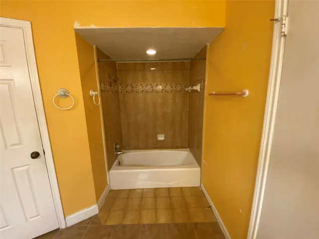 a bathroom with a shower and a tub