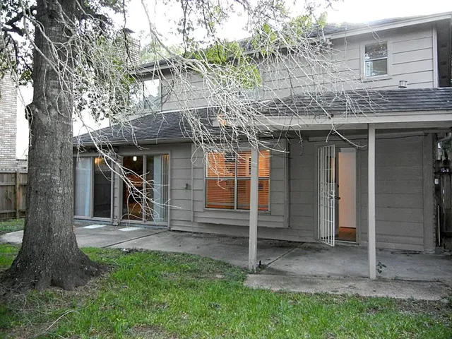 a view of a house with a tub and a tree