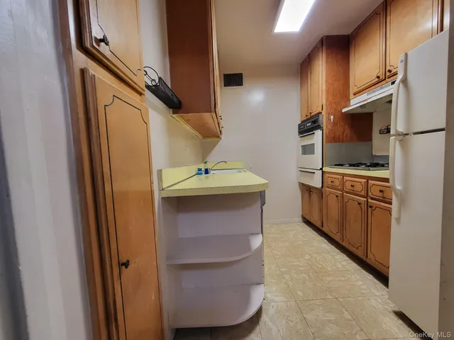 a kitchen with stainless steel appliances a refrigerator and a sink