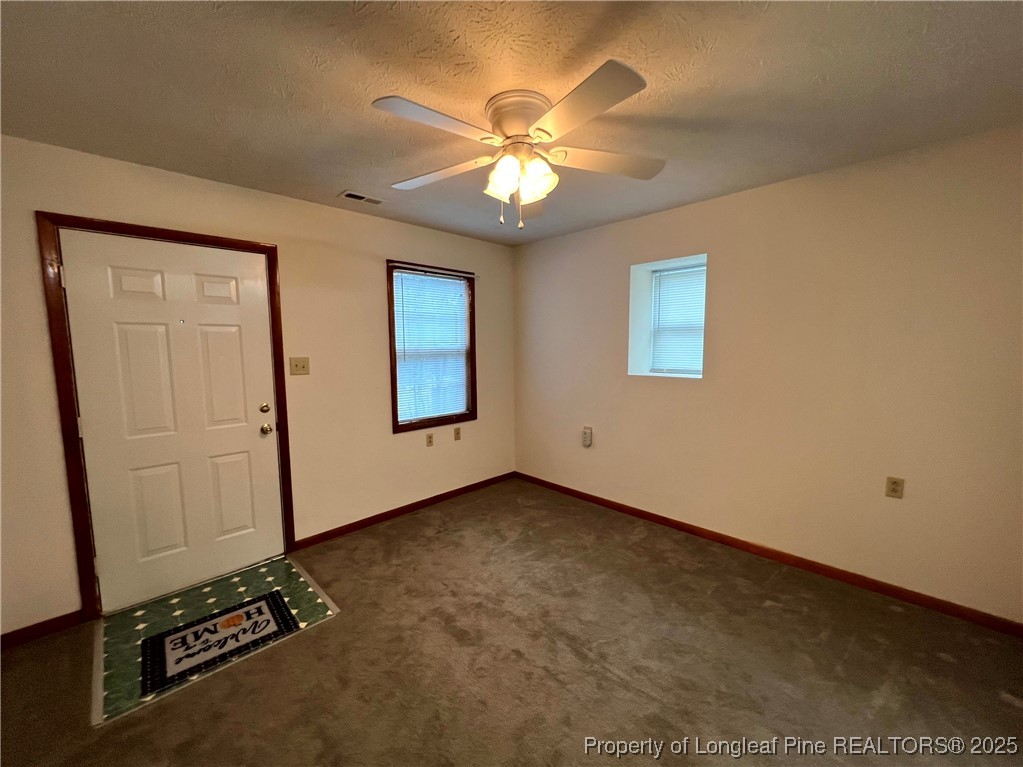 2472-2 John Hall Road Fayetteville, NC 28312 - Photo 4 of 10 an empty room with windows and fan