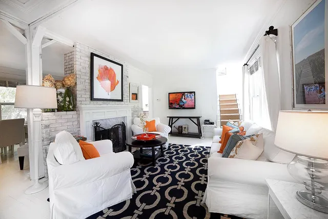 a living room with furniture a fireplace and a flat screen tv