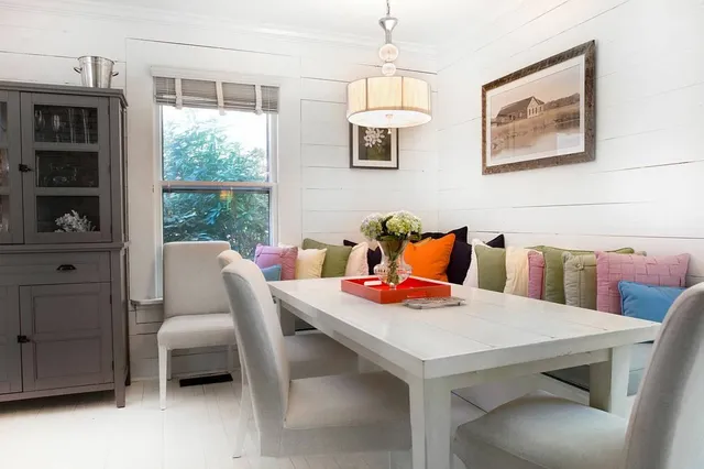 a dining room with furniture and window