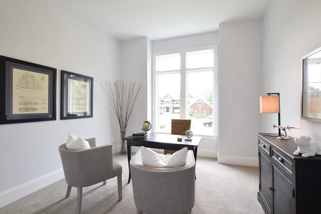a living room with furniture and floor to ceiling windows