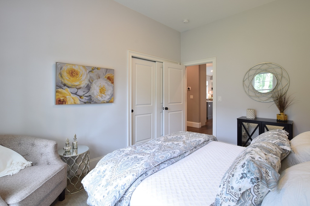 3 B Johnnies Way Rehoboth, MA 02769 - Photo 9 of 9 a bedroom with a bed and a lamp on dresser